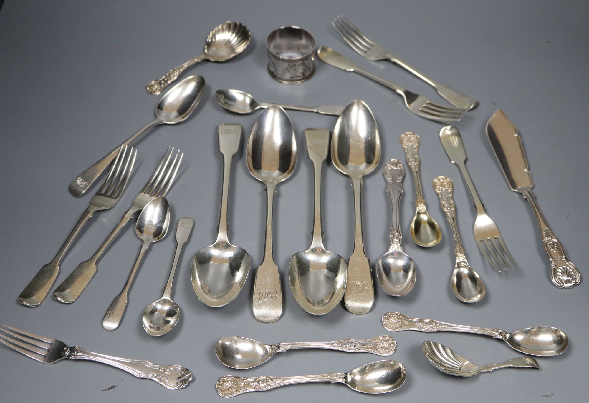 A group of assorted 19th century silver flatware including two caddy spoons (one Scottish) and a napkin ring,